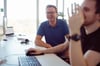 Zwei Kollegen von prodot arbeiten zusammen und lachen
