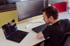 Prodot employee sitting in front of his laptop