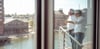 Managing directors Pascal Kremmers and Mischa Hüschen stand on the balcony and look into Duisburg's inner harbor