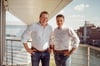 Managing Directors Mischa Hüschen and Pascal Kremmers standing in front of the Innenhafen.