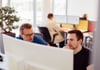 Bild: 2 Männer arbeiten im Team an einem Bildschrim